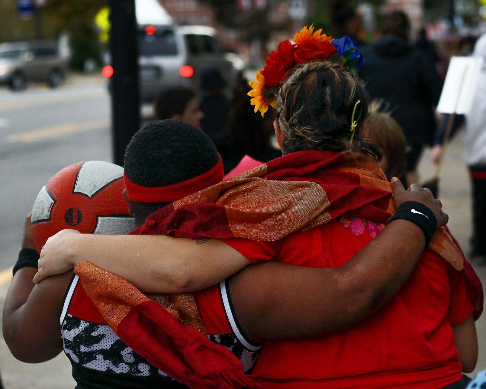Second grade teacher Kristine Kolkebeck, dressed as Frida Kahlo, puts her arm around one of her students, Thommion Riley